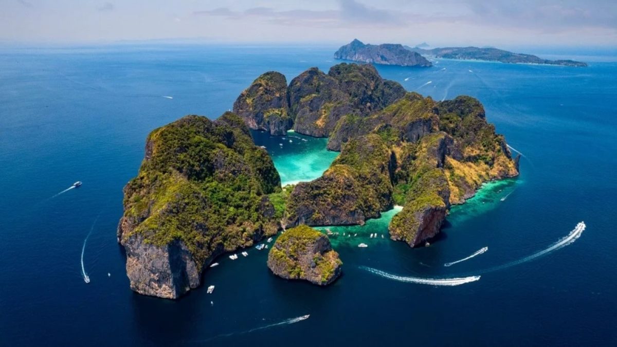 Aerial view of Phi Phi Islands with turquoise waters, limestone cliffs and tour boats in Thailand