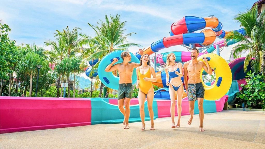 Family enjoying water slides and fun activities at Andamanda Phuket water park in Thailand